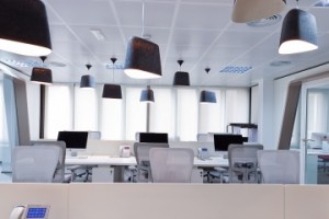 office-room-equipped-with-white-desk-modern-work-chairs-computer-on-the-table-and-black-pendant-lights